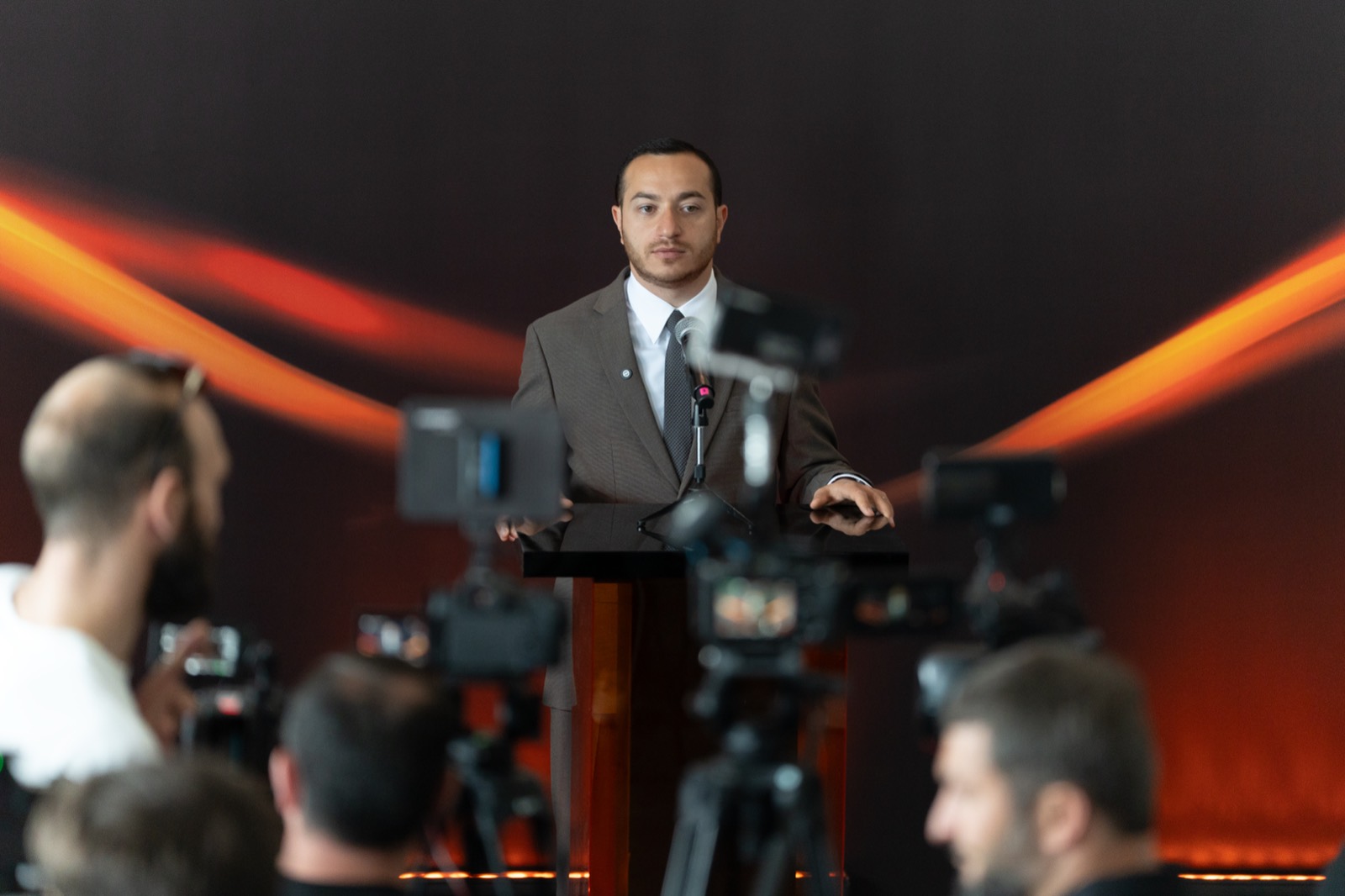 A speaker addresses media and members of Armenia’s technology community at the Firebird site tour